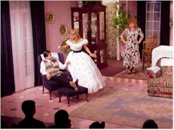 Adolph finds out after looking at the tag on her dress, that he has to get a night job to pay for it.